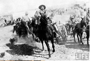  This 1914 photo courtesy of the LIFE magazine photo archive on Google shows Mexican General Pancho Villa riding with his men after victory at Torreon